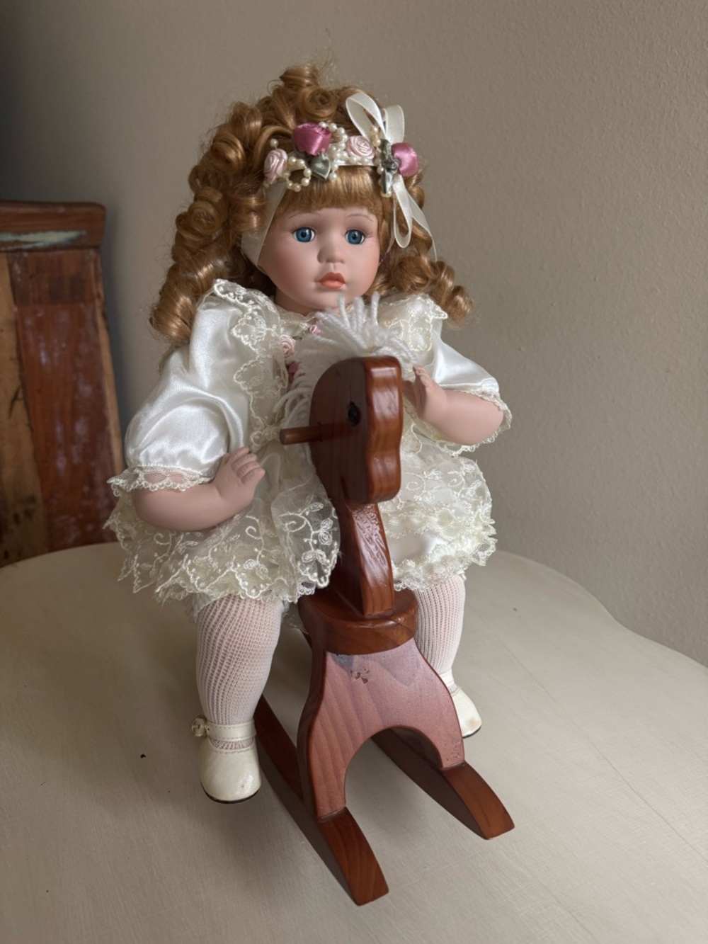 Porcelain Doll with Ivory Lace Dress and Wooden Rocking Horse